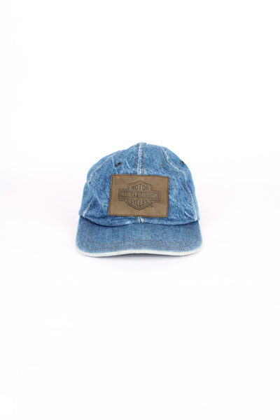 Vintage Harley Davidson denim blue cap, 100% cotton, made in USA, eyelet holes around the top, embroidered badge logo on the front and has an adjustable strap. 