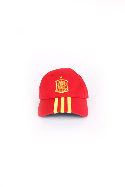 Adidas Football, Spain cap in red and yellow country colours but blue under the peak, 100% cotton, Spain football flag embroidered on the front, and has Adidas stripes as well.