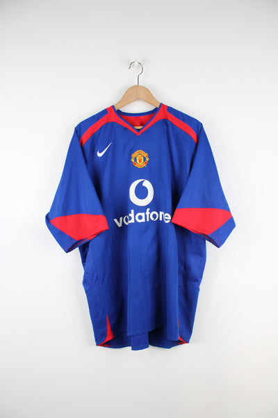 Manchester United 2005/06, Nike Football Kit in a blue, white and red colourway, V-neck and has logos embroidered on the front.