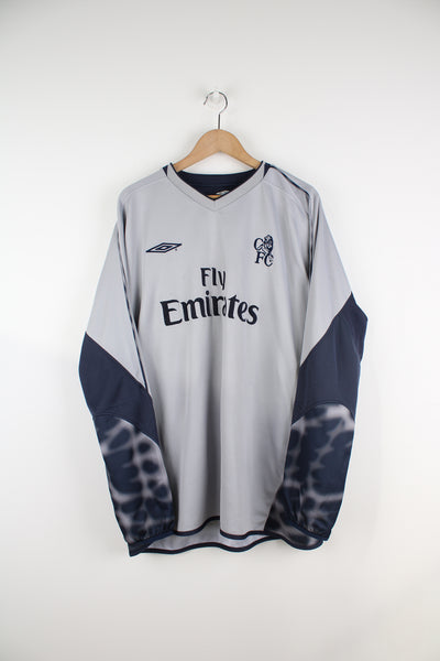 Vintage Chelsea 2003/04, Umbro Goalkeeper Football Shirt in a grey and blue colourway, long sleeved V-neck, patterned design on the back and has the logos embroidered on the front.