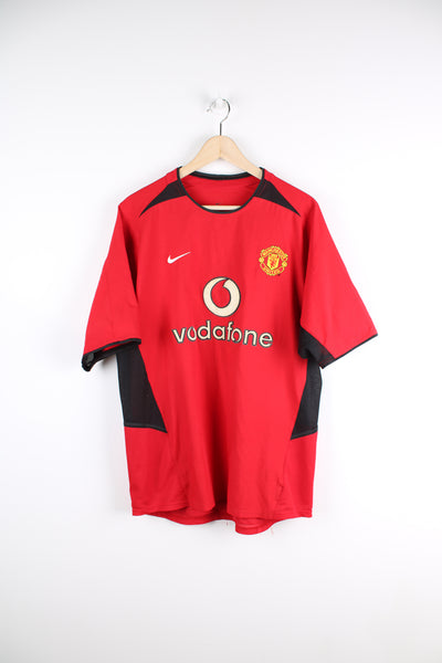 Manchester United Nike 2002/04 home football shirt, red team colourway and has embroidered logos on the front.