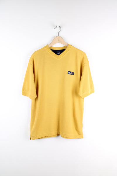 Vintage Ellesse yellow v-neck cotton t-shirt, features embroidered logo on the chest