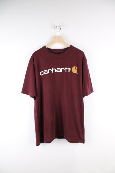 Vintage Carhartt T-shirt in burgundy, has the Carhartt logo spell out across the front, as well as on the back. 