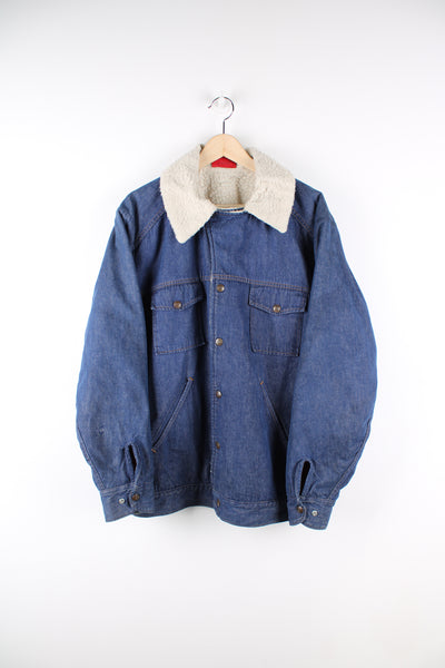 Vintage Dickies workwear denim sherpa jacket in blue, button up with multiple pockets, and has a white sherpa lining.
