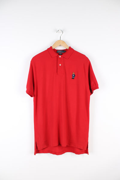Ralph Lauren all red polo shirt, features embroidered teddy bear on the chest 