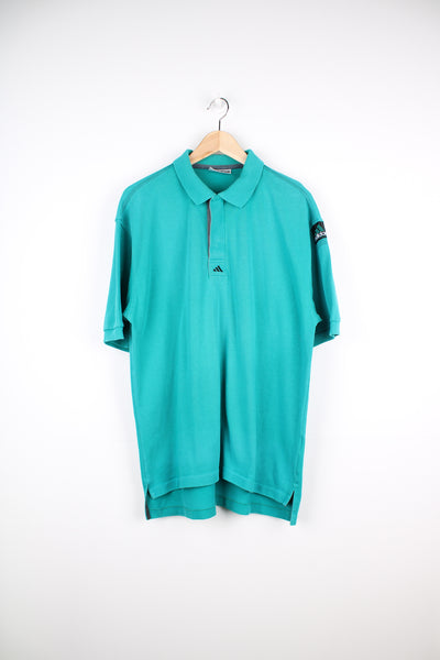 Vintage Adidas Equipment turquoise polo shirt with small embroidered logo on the chest and patch logo on the arm. good condition Size in Label: 42/ 44 - Measures like a mens L