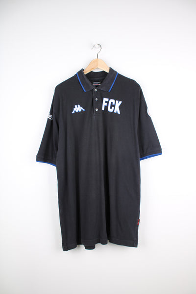 Vintage Kappa black polo shirt with embroidered Kappa logo on the chest and printed FCUK logo on the chest. Also features embroidered F.C. Københaven logo on one sleeve and Carlsberg logo on the other good condition Size in Label: Mens XXXLarge