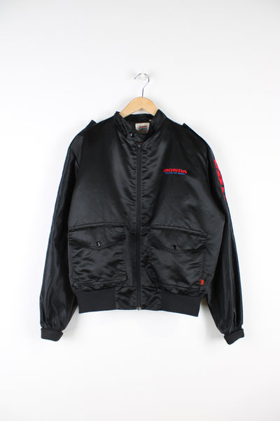 Vintage 1980's Honda black satin bomber jacket features embroidered spell-out details on the chest and down the sleeve 