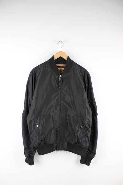 Vintage Alpha Industries bomber jacket in black, features multiple pockets