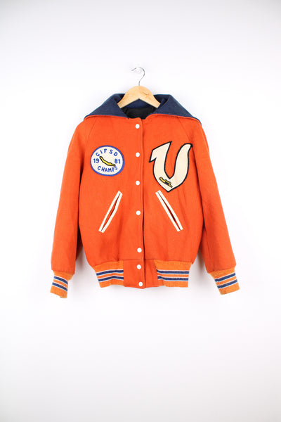 Vintage 1980s diving themed orange wool varsity jacket by Admiral Sportswear features leather sleeves and embroidered badges 