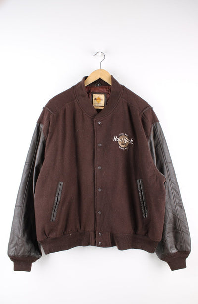 Vintage brown Hard Rock Hotel Paris varsity jacket with brown leather sleeves and embroidered badges on the front and back