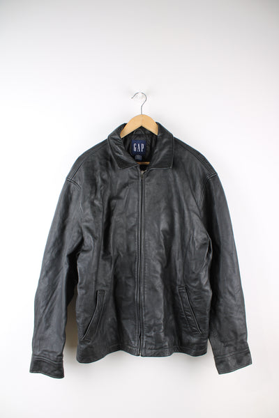 Vintage GAP all black zip through jacket, made from 100% leather. Features buckle details on the hips