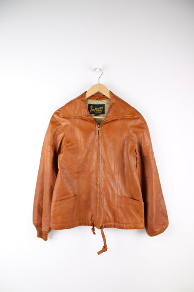 Vintage 1970's orange/tan zip through leather jacket, by Imperial. Features dagger collar, and drawstring waist 
