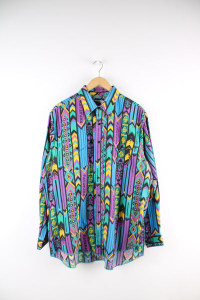 Vintage Wrangler Cowboy Cut, blue, yellow, purple, green and black patterned shirt. Features double pockets