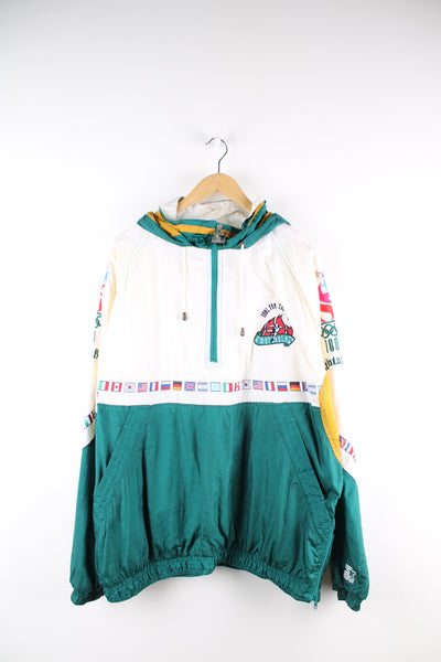Vintage 1996 Atlanta Olympics, Starter pullover shell jacket, white and green colourway, half zip with side pockets, hooded, has embroidered details throughout the jacket with international flag ribbon across the front, sleeves and the back. 