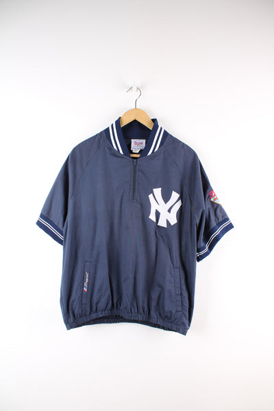 Vintage MLB New York Yankees short sleeve drill top in the blue and white team colourway, quarter zip up, has embroidered logos on the front and sleeves. 