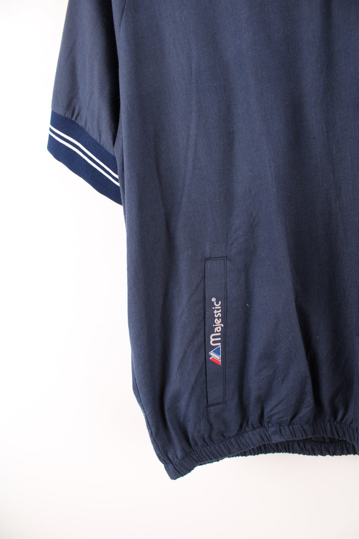 Vintage MLB New York Yankees short sleeve drill top in the blue and white team colourway, quarter zip up, has embroidered logos on the front and sleeves. 