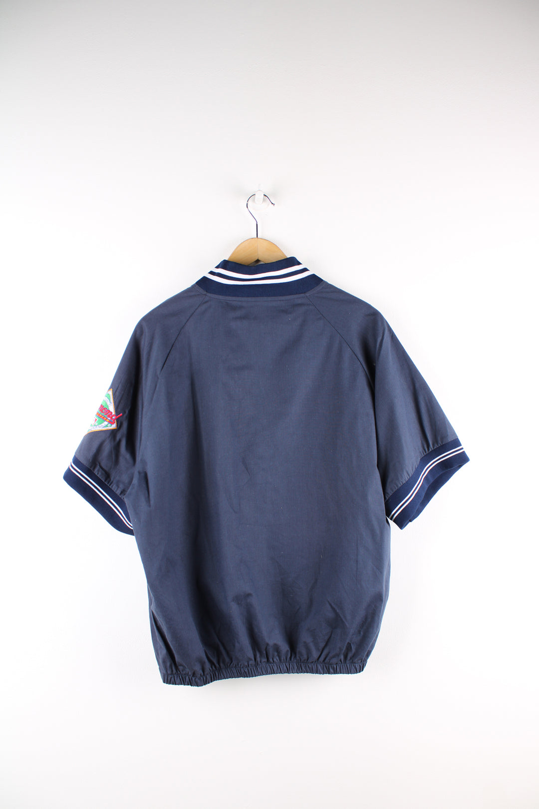 Vintage MLB New York Yankees short sleeve drill top in the blue and white team colourway, quarter zip up, has embroidered logos on the front and sleeves. 