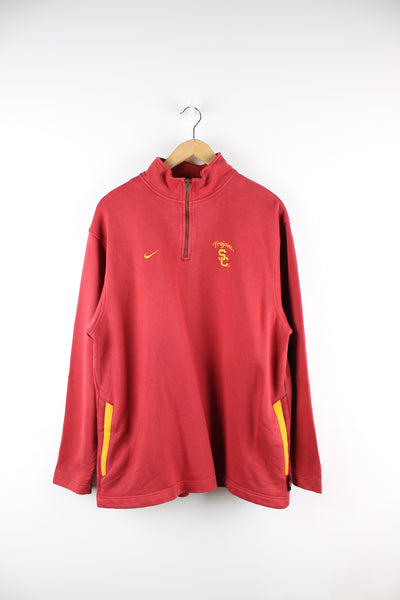 Vintage University of Southern California, Nike sweatshirt in red, quarter zip up with side pockets, has embroidered logos on the front and back. 
