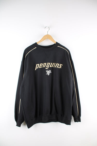 Vintage Pittsburgh Penguins NHL sweatshirt in black, crewneck with embroidered spell out and logo across the front. 