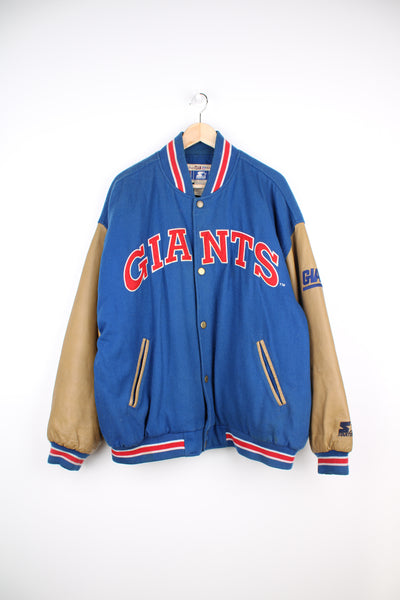 90's New York Giants varsity jacket with blue wool body and tan leather arms. Features embroidered logos on the arms and felt applique logo across the chest  good condition - Discoloration around the collar and scuffs to the leather on the arms and bobbling through out (see photos) Size in Label: Mens XL 