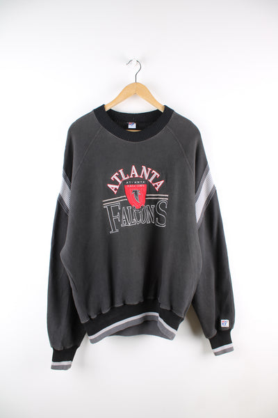 Vintage NFL Atlanta Falcons sweatshirt in black, grey and red team colourway, crewneck with embroidered spell out and logo across the front. 