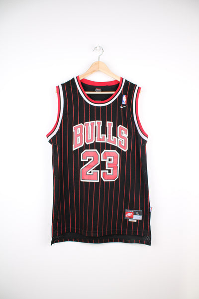 Michael Jordan #23 for Chicago Bulls, black basketball jersey by Nike. Features embroidered spell-out details on the front and back. good condition- creases and some cracking on the lettering (see photos) Size in Label: Mens L 