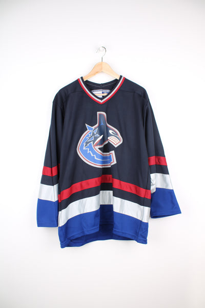 NHL Vancouver Canucks Jersey by CCM. Features printed Canucks logo on the front and plain back. good condition Size in Label: Mens M 