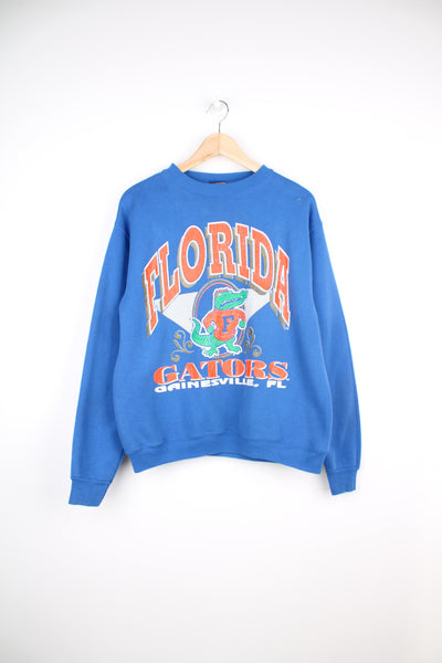 Vintage 90's Florida Gators blue sweatshirt with printed graphic on the front. Made by Savvy. good condition - mark on the shoulder and cracking to the graphic (see photos) Size in Label:  Mens M 