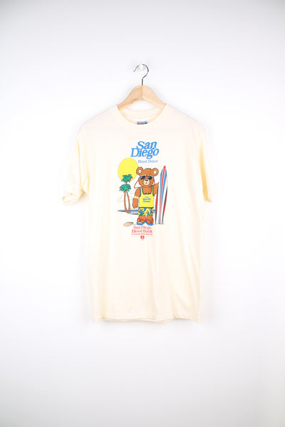 Vintage San Diego Blood Donor, Surfer Bear T-Shirt in a tan colourway with graphic design printed on the front, Hanes fifty fifty label and is single stitch.