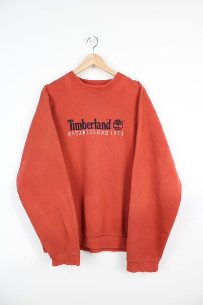 Timberland burnt orange / red crewneck sweatshirt with embroidered spell-out logo across the chest