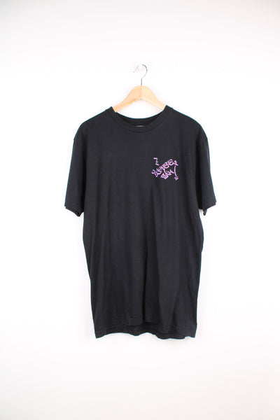 Vintage Stussy with spell-out graphic on the front and cowboy graphic on the back
