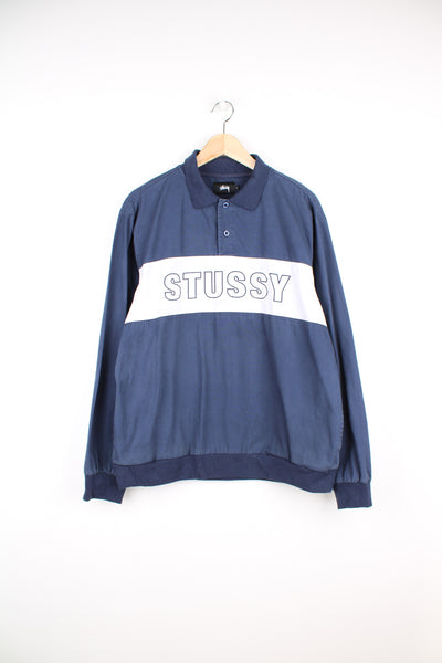 Stussy pullover rugby style training top, in navy. Features large spell-out logo across the chest