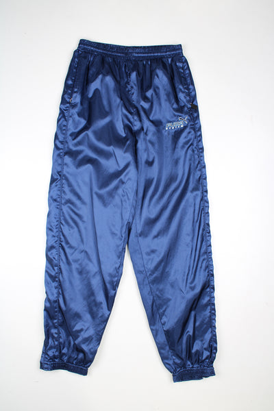 Vintage Puma System tracksuit bottoms in a blue colourway, elasticated waist and cuffed at the bottom, has logo embroidered on the front.