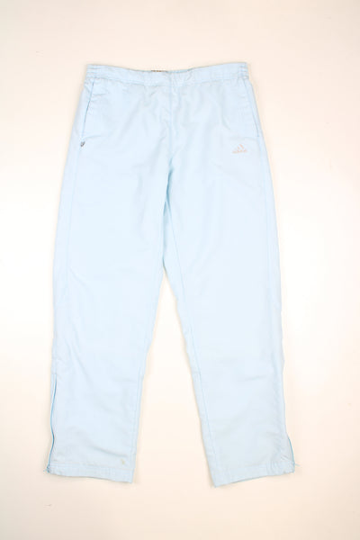 Vintage Adidas tracksuit bottoms in a baby blue colourway, elasticated waist, pockets and has logo embroidered on the front.