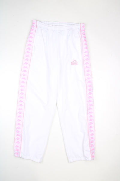 Vintage Kappa tracksuit bottoms in a white colourway with pink logo going down the sides, elasticated waist, and has logo embroidered on the front.