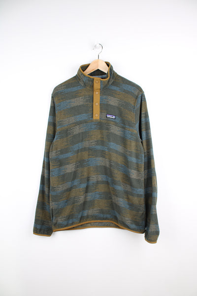 Patagonia Fleece in a patterned green, brown and blue colourway, quarter button up, and has logo embroidered on the chest.