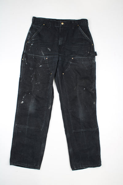 Carhartt black denim carpenter jeans with multiple pockets and double knees