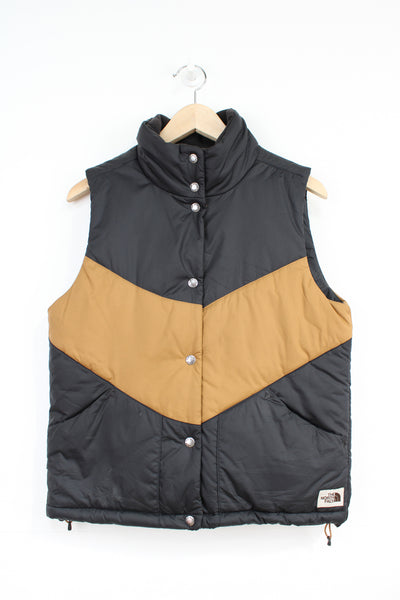 The North Face 'Sylvester' brown and black button up puffer gilet with embroidered logo on the hem