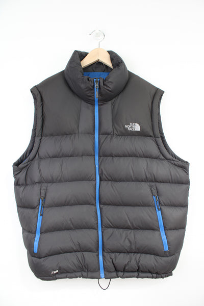 The North Face 700 black puffer gilet blue zippers, kangaroo pockets and embroidered logos on the front and back