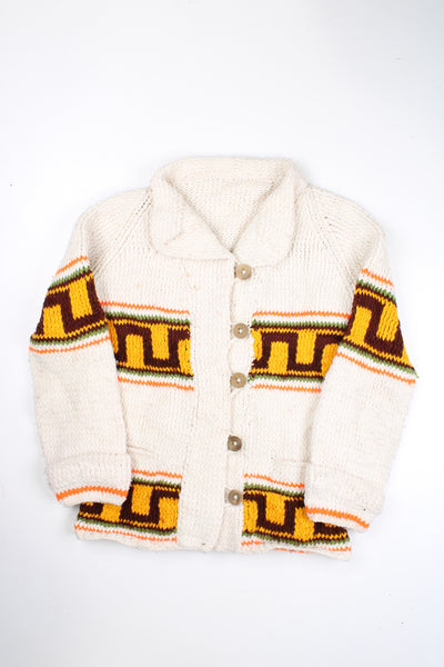 Vintage cream knit cardigan with orange geometric design. No tag, looks hand made. Would estimate its from the 60's. Closes with wooden buttons.   good condition - two very faint marks on the chest (see photos)  Size in Label:  N/A- measures like an M