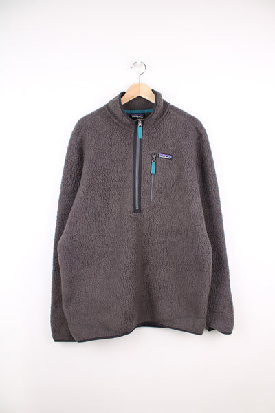 Patagonia Fleece in a grey colourway, half zip up, chest pocket and has the logo embroidered on the front.