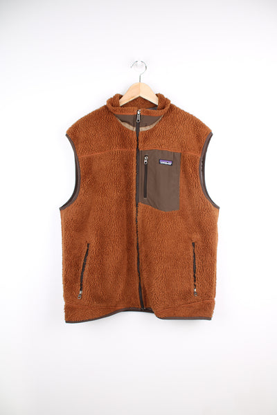 Patagonia Fleece Vest in a brown colourway, zip up, multiple pockets and has the logo embroidered on the chest.