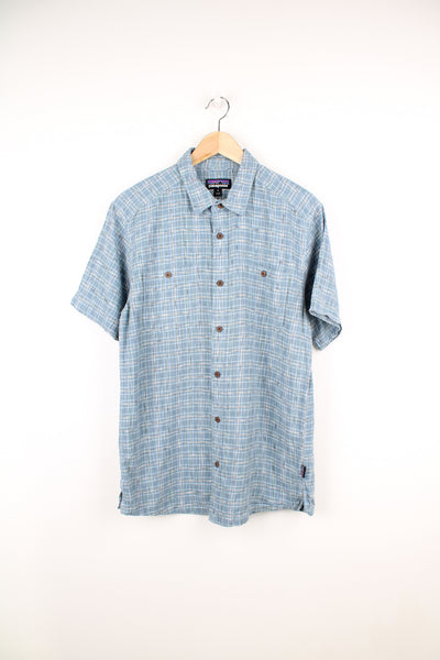 Patagonia Short Sleeve Plaid Shirt in a blue and white colourway, button up, double chest pockets and has the logo embroidered on the side.