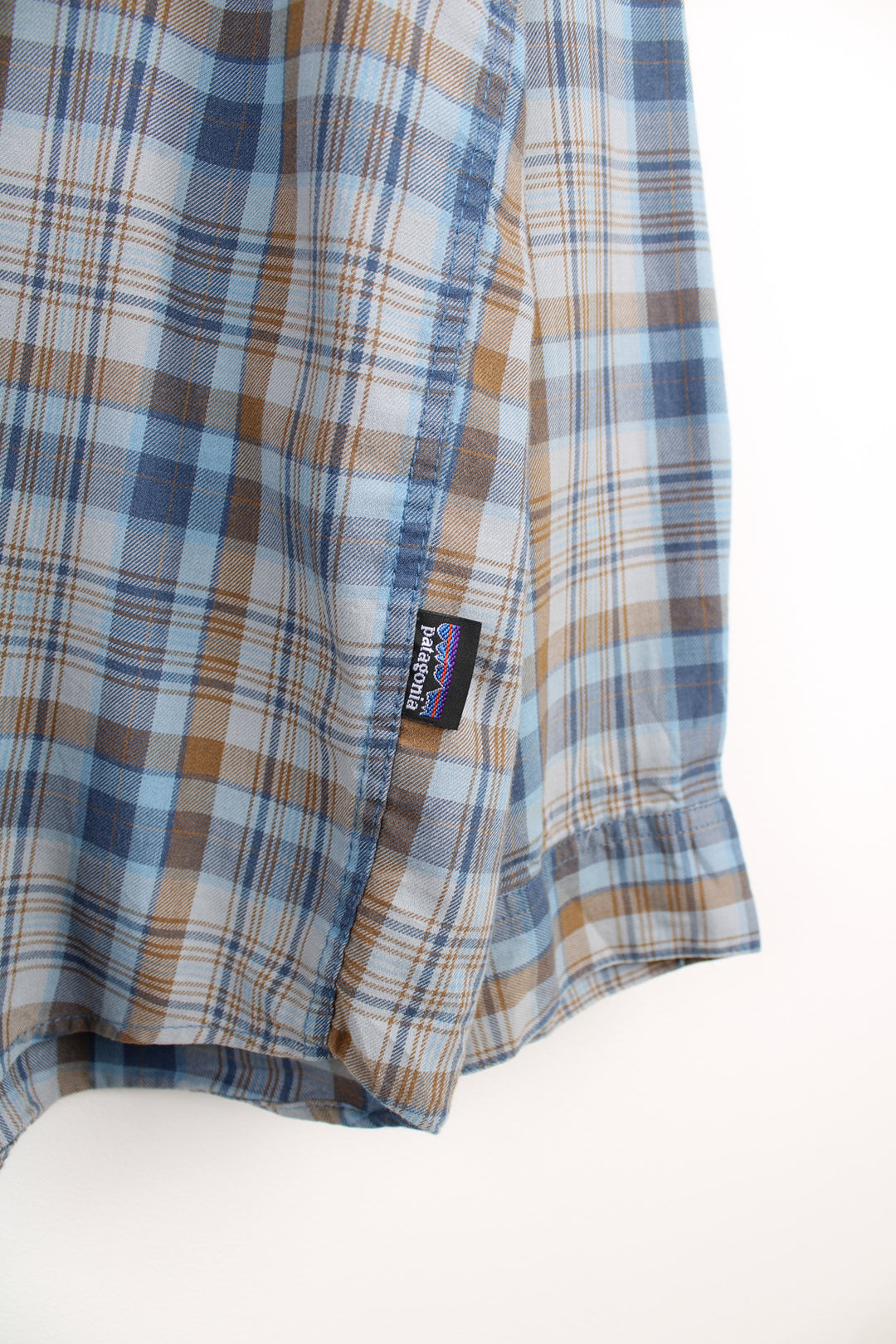 Patagonia Plaid Shirt in a blue and brown colourway, button up, double chest pockets and has the logo embroidered on the side.