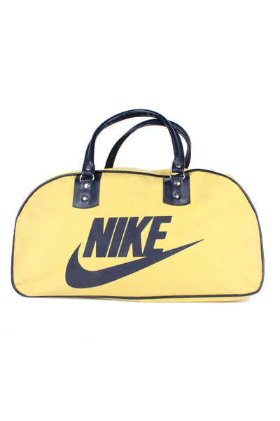 Vintage 1970s yellow and blue Nike spell-out duffle bag with printed spell-out logo on the side 