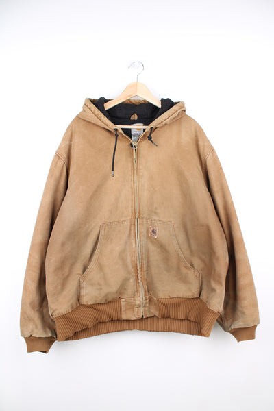 Carhartt Active Jacket in a tan colourway, heavy cotton lining, zip up, hooded and has the logo embroidered on the pocket.