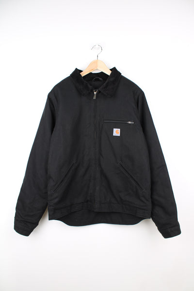 Carhartt Detroit Jacket in a black colourway, corduroy collar, blanket lining, zip up, multiple pocket and has the logo embroidered on the front.