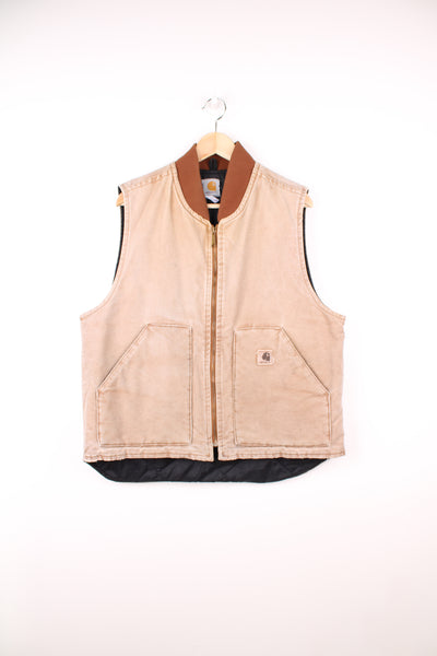 Carhartt Workwear Gilet in a tan / faded brown colourway, zip up, quilted lining, and has the logo embroidered on the front pocket.