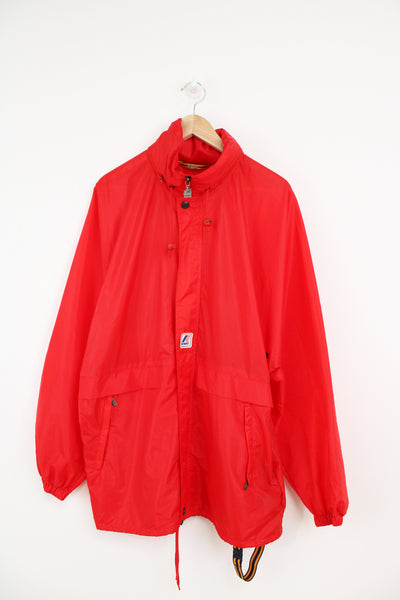 K-way red zip through windbreaker with embroidered badge on the front and foldaway hood